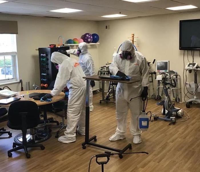 Multiple technicians cleaning the same space