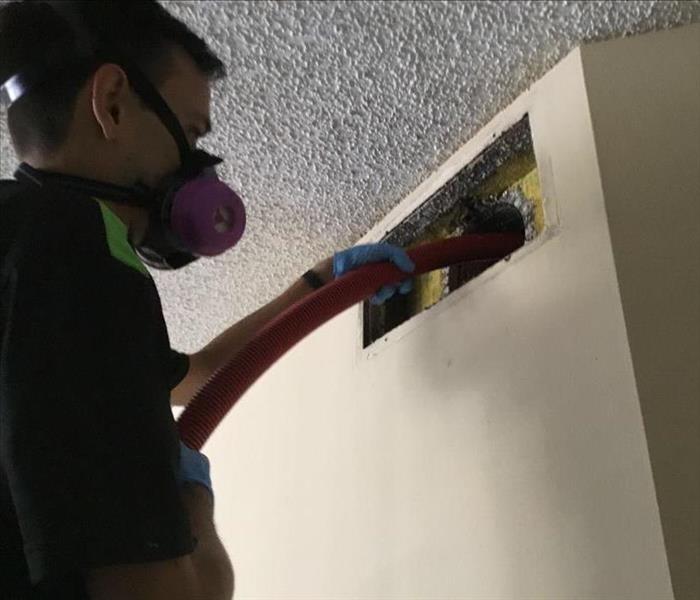 SERVPRO technician cleaning an air duct