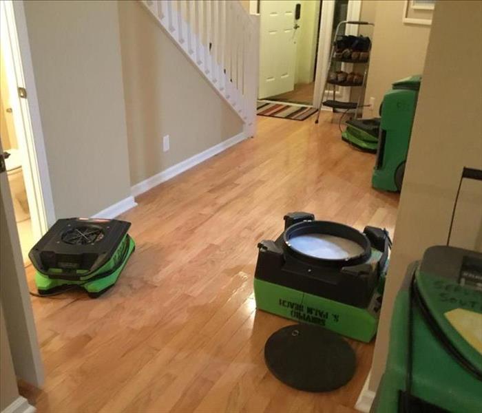 Air movers and drying equipment in front entry of a house
